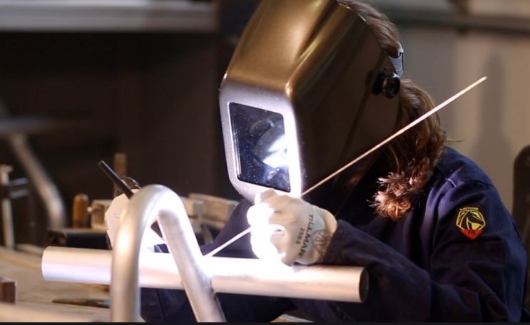 privacy - welder at work on a curved metal part