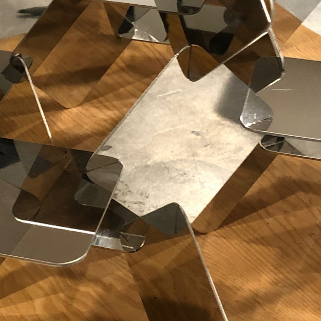 Interconnect solution shown to hold the polished mirror pieces together without diminishing the beauty of the piece.